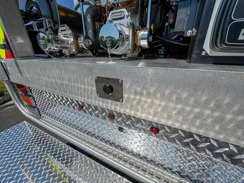 Rear bumper and tailboard view with chevron panel and step platform.